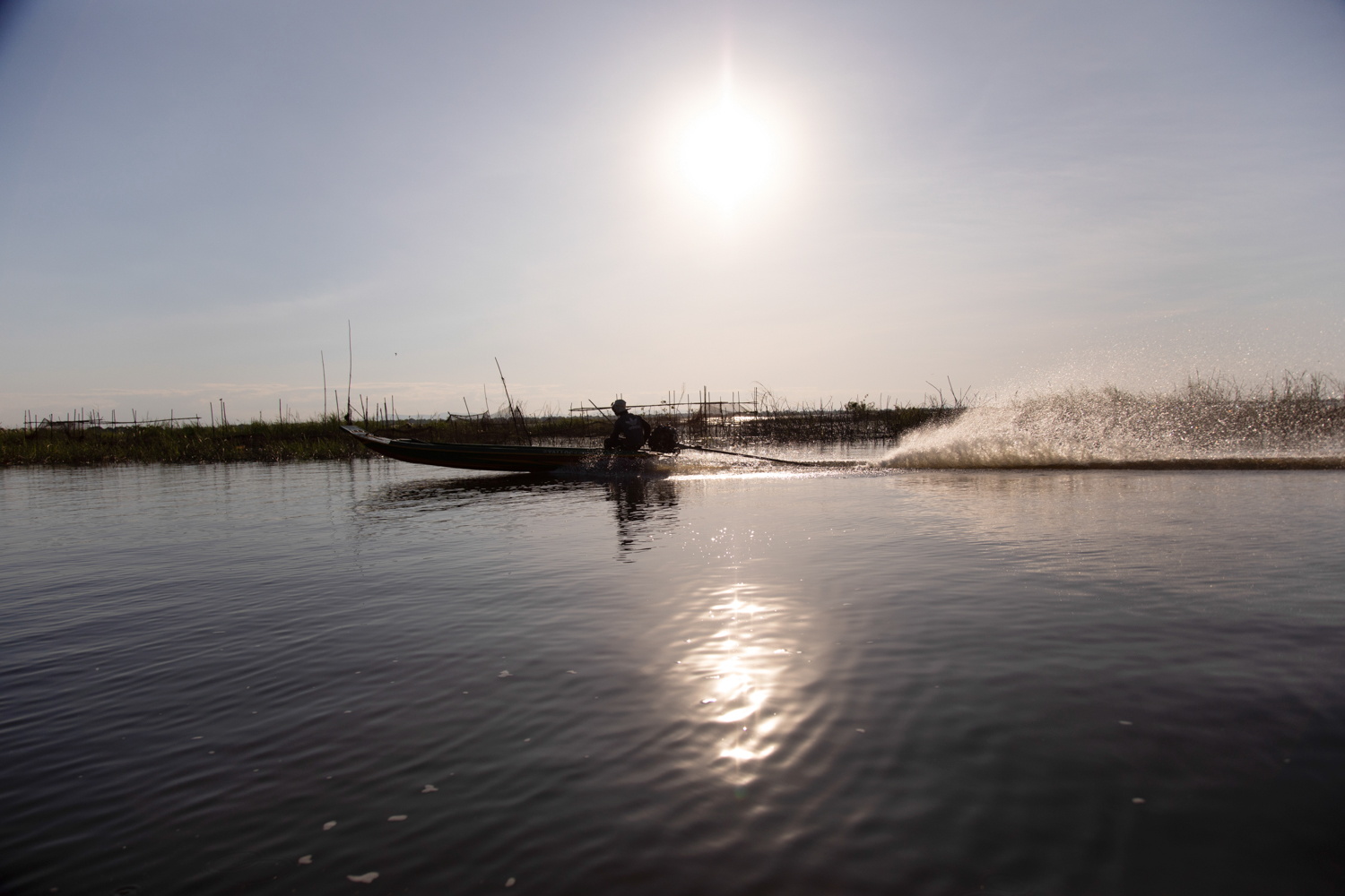 Boat on a lake in Cambodia — fine art photography by Jo Allaux